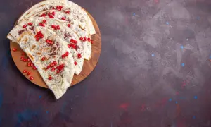 Plastry tortilli z granatem i przyprawami, idealne, by dowiedzieć się, jak podgrzać tortillę, żeby była miękka.